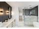 Elegant bathroom featuring double vanity, soaking tub, and a walk-in shower at 4121 Kalamath St, Denver, CO 80211