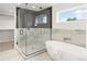 Spa-like bathroom with soaking tub, glass-enclosed shower, and marble finishes at 4121 Kalamath St, Denver, CO 80211