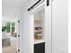 Bright hallway with built-in shelving and laundry area at 4121 Kalamath St, Denver, CO 80211