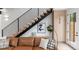 Modern floating staircase with black metal railing and light wood steps at 4121 Kalamath St, Denver, CO 80211