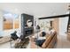 Open living room with modern fireplace and view into the kitchen area at 4121 Kalamath St, Denver, CO 80211