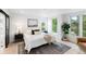 Bright bedroom with a king-size bed, large windows, and a neutral color scheme at 4121 Kalamath St, Denver, CO 80211