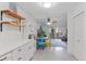 Kitchen and dining area with white cabinets and wood shelves at 595 S Alton Way # 1C, Denver, CO 80247