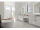 Luxurious bathroom with double vanity, soaking tub, and marble floors at 29775 E 162Nd Ave, Brighton, CO 80603