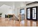 Spacious entryway with hardwood floors, staircase, and modern light fixtures at 29775 E 162Nd Ave, Brighton, CO 80603
