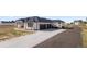 A large, modern home with a three-car garage and a long driveway at 29775 E 162Nd Ave, Brighton, CO 80603