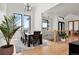 Elegant dining room with hardwood floors, large windows, and a modern chandelier at 29775 E 162Nd Ave, Brighton, CO 80603