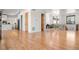 Open living room with hardwood floors, and access to kitchen and dining area at 29775 E 162Nd Ave, Brighton, CO 80603