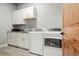 Laundry room with white cabinets, granite countertops, and washer/dryer at 29775 E 162Nd Ave, Brighton, CO 80603