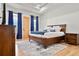 Main bedroom with wood platform bed and walk-in closet at 29775 E 162Nd Ave, Brighton, CO 80603