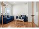 Bright office space with hardwood floors and two blue sofas at 29775 E 162Nd Ave, Brighton, CO 80603