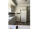 Kitchen with white cabinets, appliances, and wood-look floors at 2792 S Macon Cir, Aurora, CO 80014