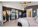 Main bedroom with king bed, barn door to ensuite, and TV at 299 N Catawba Ct, Aurora, CO 80018
