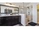 Bathroom with double vanity, large mirror, and glass shower at 299 N Catawba Ct, Aurora, CO 80018