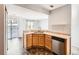 Kitchen boasts a corner sink and stainless steel dishwasher at 5888 Biscay St # D, Denver, CO 80249