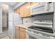 Bright kitchen features white appliances and light wood cabinets at 1020 15Th St # 7A, Denver, CO 80202