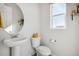 Simple powder room with pedestal sink and bright window at 60 S Trussville St, Aurora, CO 80018