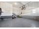 Spacious garage with epoxy flooring, storage, and a bike lift at 60 S Trussville St, Aurora, CO 80018