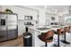 Modern kitchen with white cabinets, stainless steel appliances and breakfast bar at 60 S Trussville St, Aurora, CO 80018