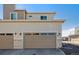 Beige two-story townhome with a two-car garage at 60 S Trussville St, Aurora, CO 80018