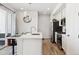Modern kitchen with white cabinets, stainless steel appliances, and island with seating at 60 S Trussville St, Aurora, CO 80018