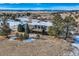 Aerial view of house on snow covered lot with mountain views at 4805 Moonshine Ridge Trl, Parker, CO 80134