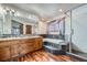 Main bathroom with double vanity, soaking tub, and walk-in shower at 4805 Moonshine Ridge Trl, Parker, CO 80134