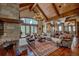 Spacious living room with vaulted ceilings, stone fireplace, hardwood floors, and large windows at 45 Kerrigan Ct, Breckenridge, CO 80424