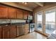 Kitchen with wood cabinets, granite counters, and balcony access at 1441 N Humboldt St # 504, Denver, CO 80218