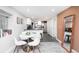 Modern kitchen with island, white cabinets, and dining area at 3443 Lawrence St, Denver, CO 80205