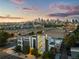 Aerial view of a modern three-story home with city skyline in the background at 1330 W 35Th Ave, Denver, CO 80211