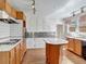 Kitchen with wood cabinets, tiled countertops, and an island at 155 N Downing St, Denver, CO 80218