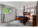 Spacious bedroom with a wooden post bed and ample natural light at 3058 S Galena Ct, Denver, CO 80231