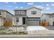 Two-story house with gray siding, gray garage door, and a well-manicured lawn at 4566 Boone Cir, Brighton, CO 80601