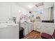 Basement laundry room with washer, dryer, and cabinets at 1340 Xanthia St, Denver, CO 80220