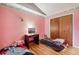 Small bedroom with pink walls, twin beds, and wood floors at 1340 Xanthia St, Denver, CO 80220