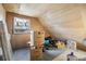 Unfinished attic space with window and storage boxes at 1340 Xanthia St, Denver, CO 80220