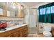 Bathroom with shower, toilet, and wood vanity at 1340 Xanthia St, Denver, CO 80220