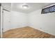 Simple basement bedroom with laminate flooring at 1340 Xanthia St, Denver, CO 80220
