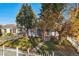 House exterior with white picket fence and mature trees at 1340 Xanthia St, Denver, CO 80220