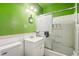 Green bathroom with tub and shower at 1340 Xanthia St, Denver, CO 80220