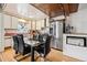 Bright kitchen with wood cabinets, glass table, and stainless steel appliances at 1340 Xanthia St, Denver, CO 80220