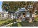 Front view of a charming house with tree-lined street at 1340 Xanthia St, Denver, CO 80220