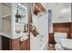 Small bathroom with shower/tub, built-in shelving, and wood paneling at 3637 Lowell Blvd, Denver, CO 80211