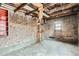 Brick garage with overhead storage and exposed beams at 3637 Lowell Blvd, Denver, CO 80211