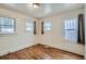 Spacious bedroom with hardwood floors and multiple windows at 3637 Lowell Blvd, Denver, CO 80211