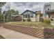 Front view of a charming bungalow with a brick wall at 3637 Lowell Blvd, Denver, CO 80211