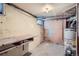 Unfinished basement area with water heater and workbench at 3637 Lowell Blvd, Denver, CO 80211