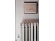 White radiator with decorative detailing and a modern thermostat at 836 E 17Th Ave # 2E, Denver, CO 80218