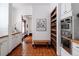 Clean kitchen with white cabinets, stainless steel appliances, and terracotta tile floors at 836 E 17Th Ave # 2E, Denver, CO 80218